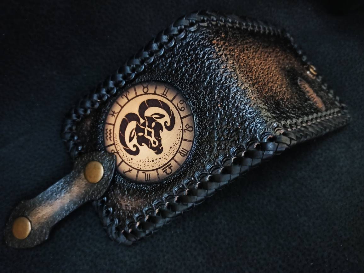 Leather handcrafted wallets for men, personalized with the zodiac symbols and the initials of the owner.